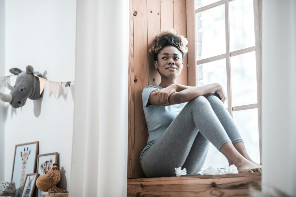 Quiet postpartum moment representing emotional overwhelm and need for space